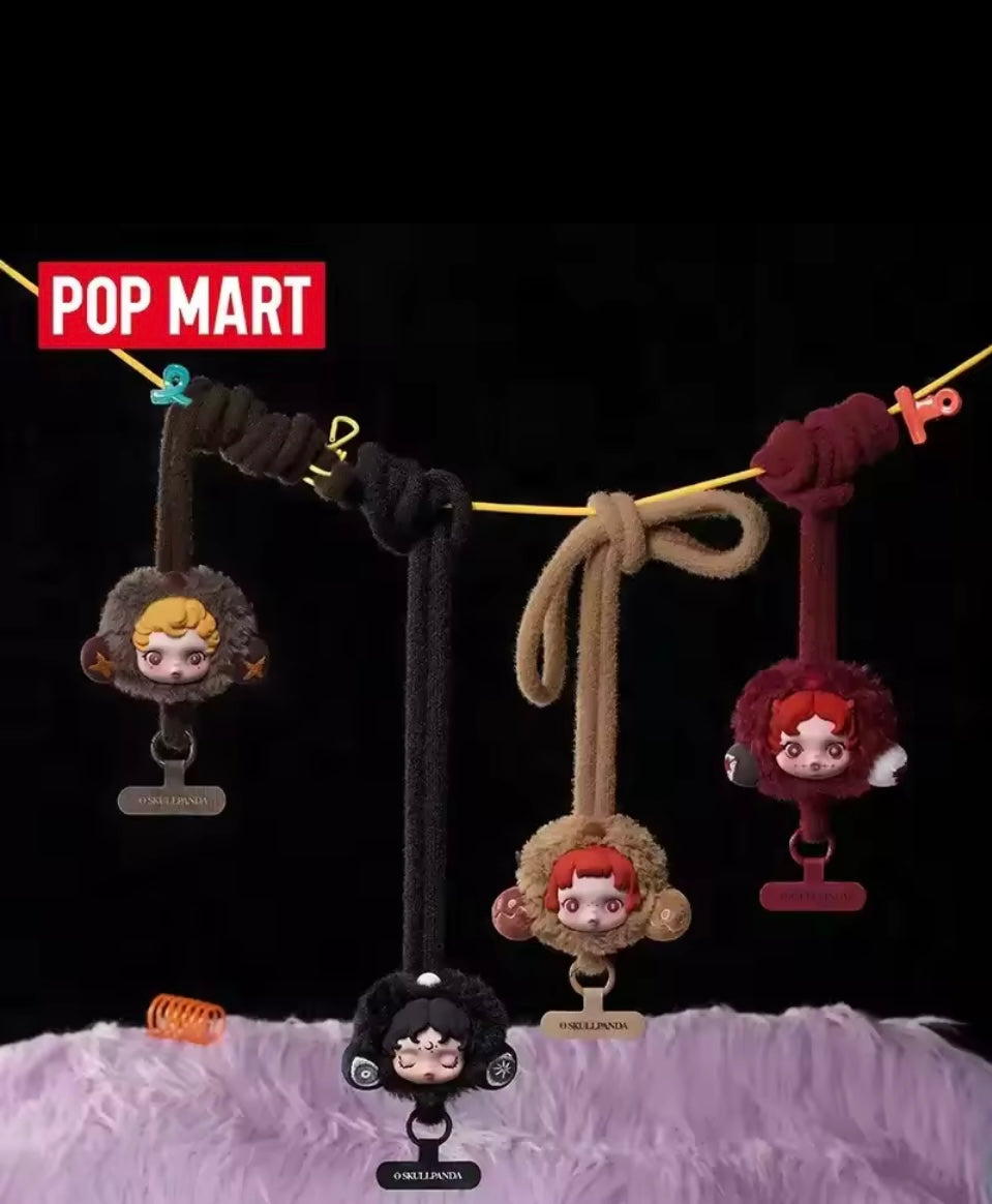 Four phone lanyard charms  hanging on a string with 'Pop Mart' branding above. Blind box collectible 
