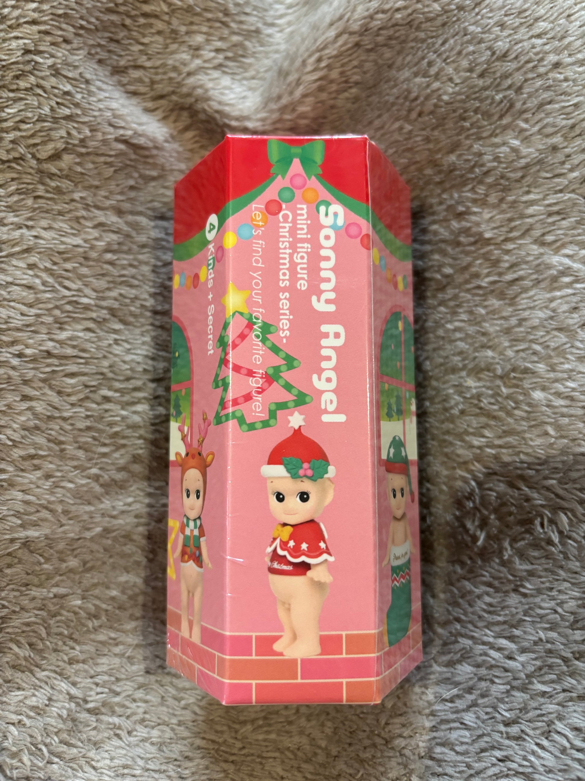 Sonny Angel Christmas Rare Blind Box resting on grey blanket 