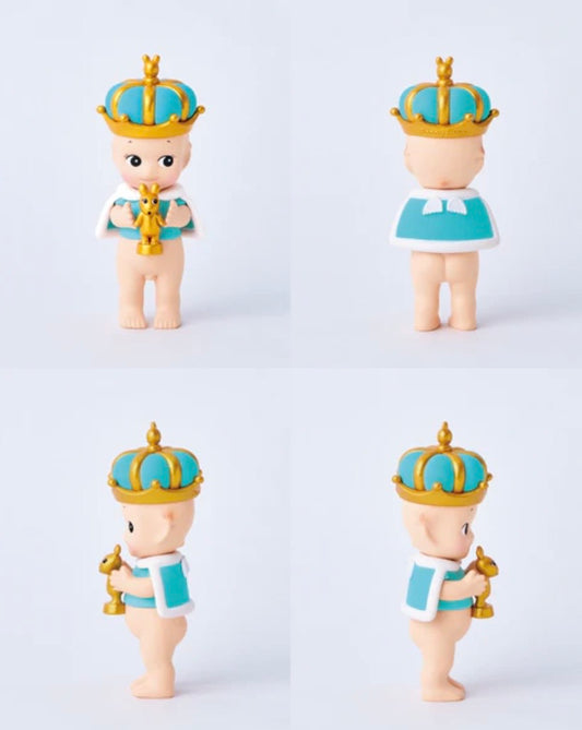 Four Sonny Angel topaz special congratulations figurine wearing blue crowns and holding gold scepters on a light gray background