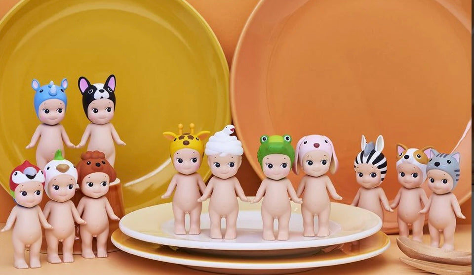 Set of sonny angel mini figurines with various hairstyles and accessories on a yellow plate from animal V3 series 
