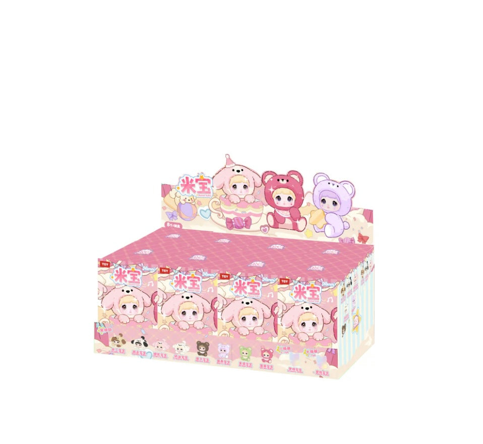 Box of baby nommi bag charm blind box collectible  toys with a pink and white design on a white background