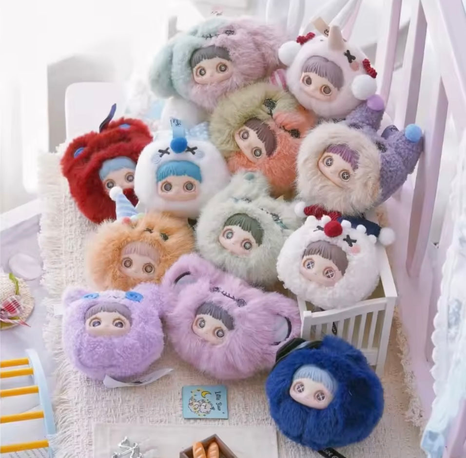 Collection of colorful plush toys with cartoon faces on a white surface.